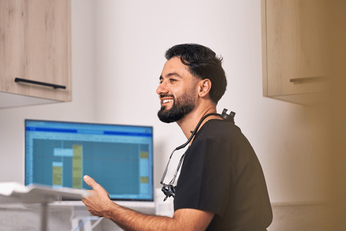 A photograph of a dentist smiling