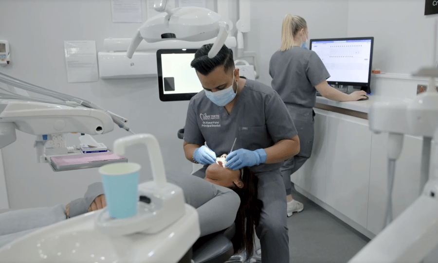 Dentist looking at patients teeth